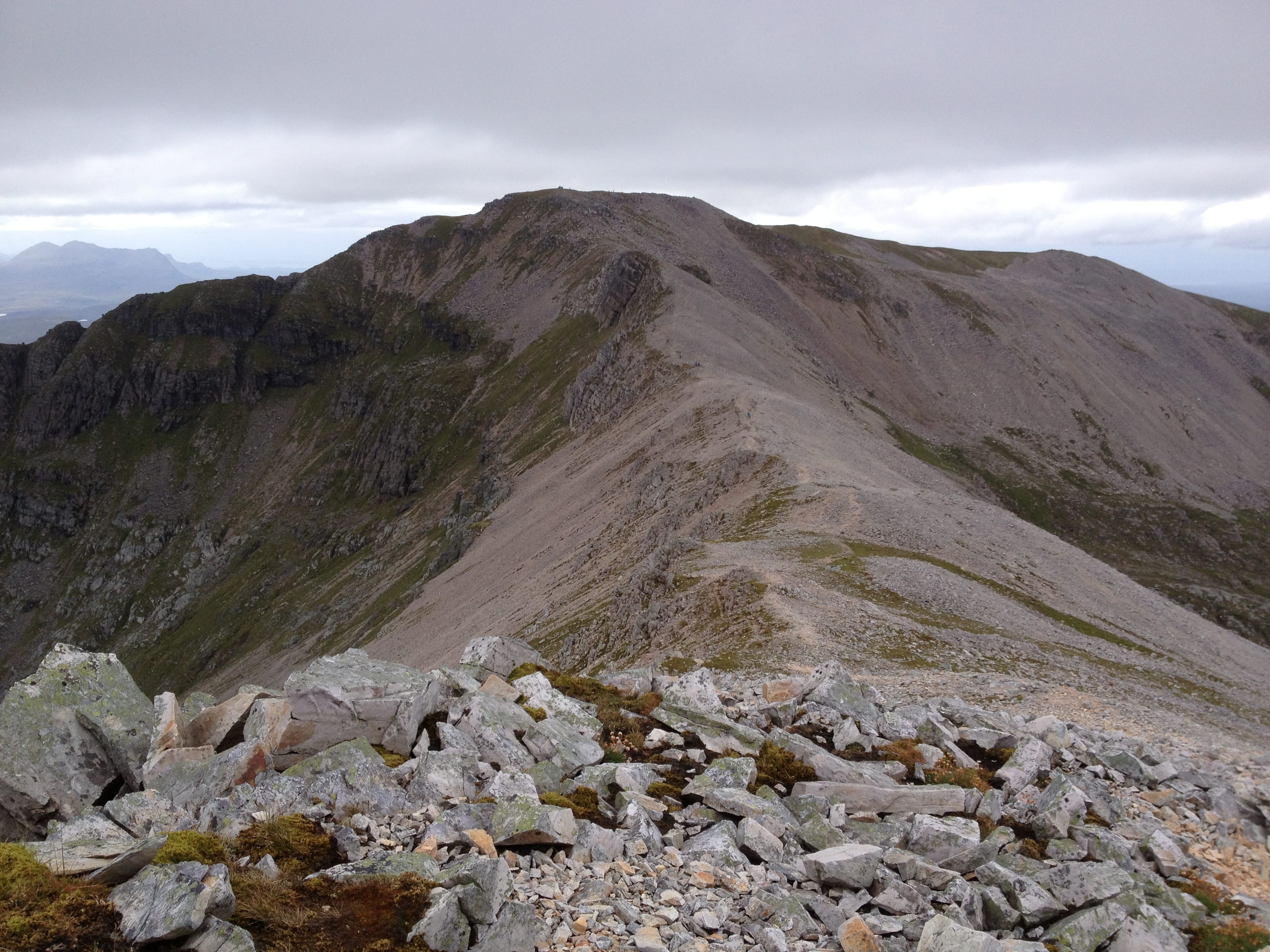 GOLD AND GREY: Looking ahead to the rocky slopes of Conival from the connecting ridge with Ben More Assynt