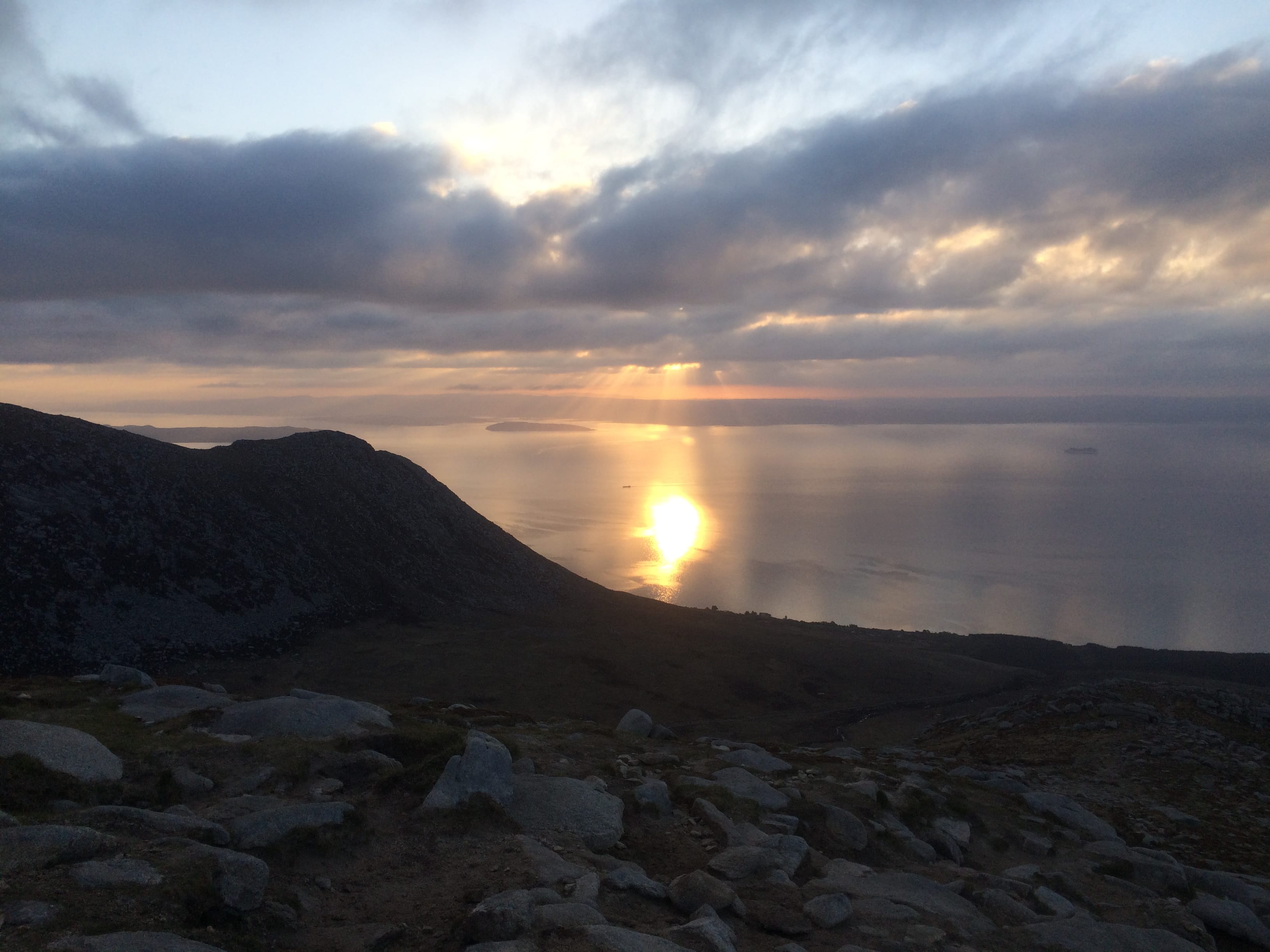 MORNING GLORY: The rising sun bursts through the lines of cloud to light up the water during the descent of Arran's highest peak Goatfell