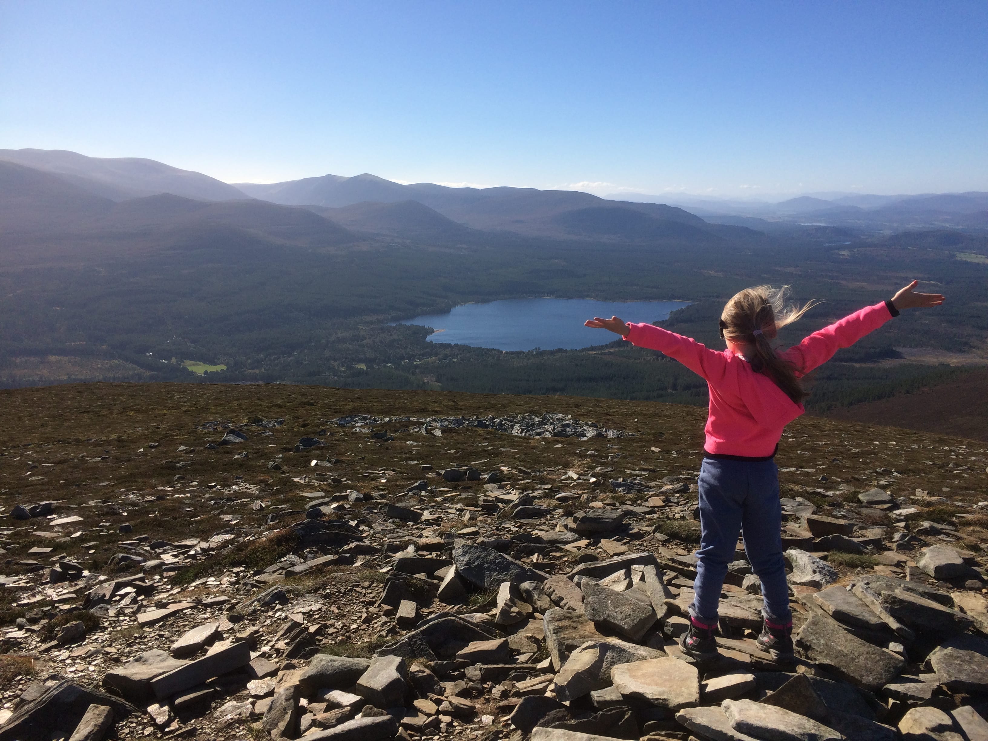 SUMMIT SPECIAL: Ava celebrates her first mountain ascent with a victory pose at the top of Meall a' Bhuachaille