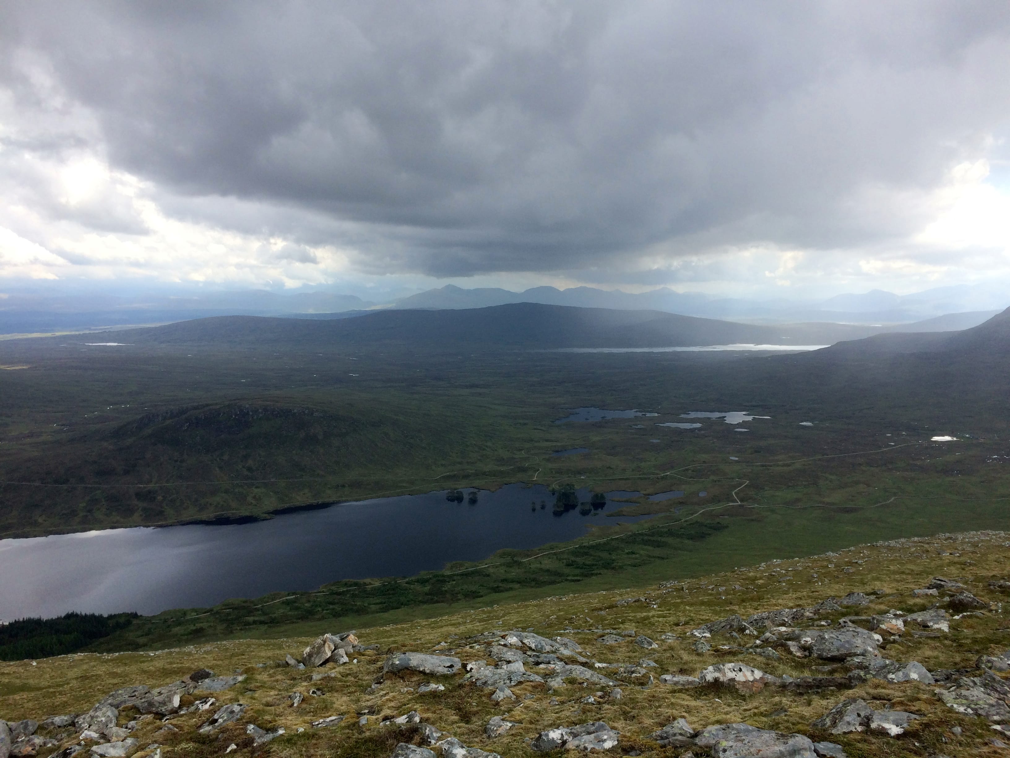 STORMY WEATHER: Black skies and thunder and lightning close in over Loch Ossian during the descent of Beinn na Lap