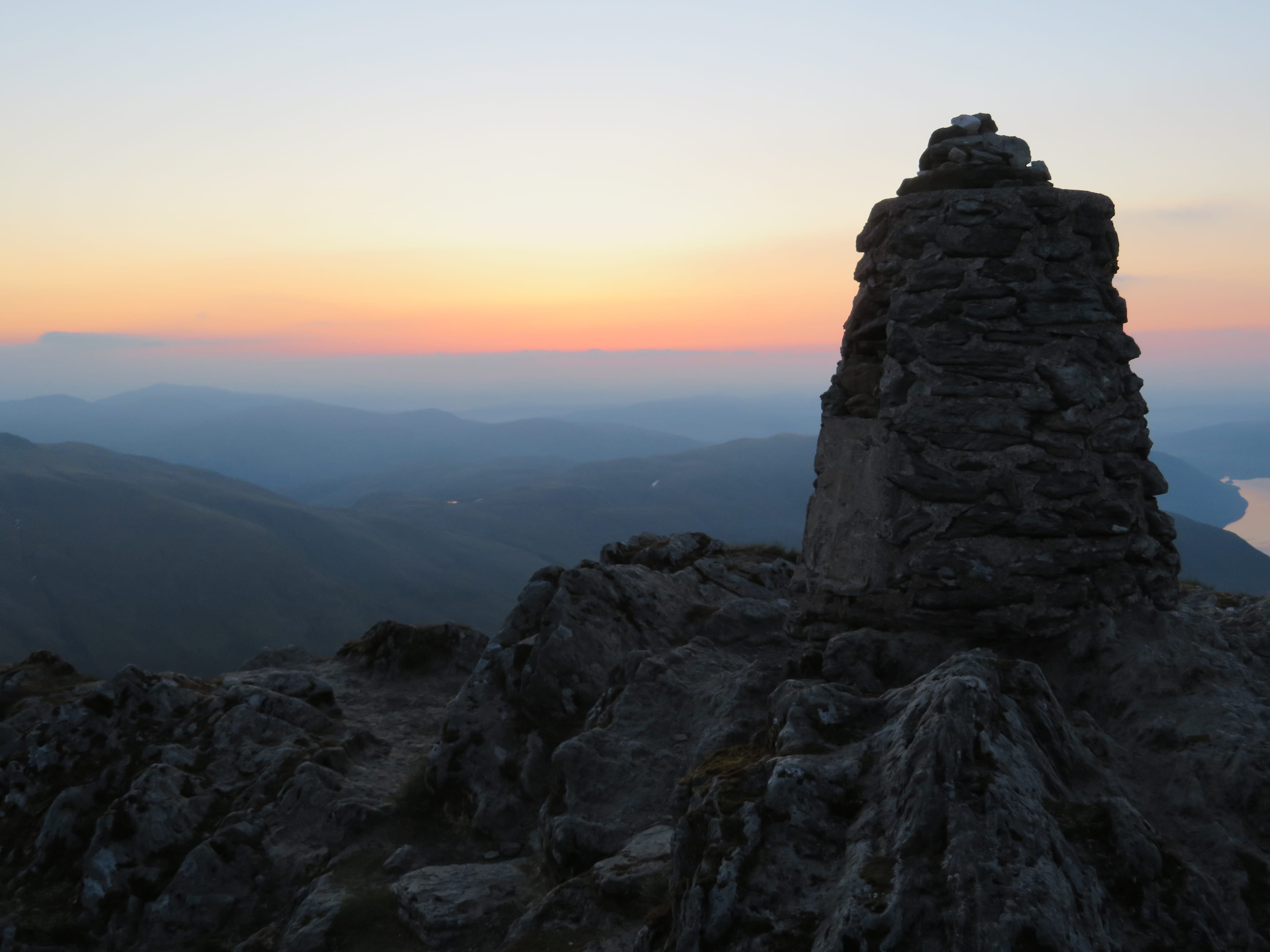 DAWN PATROL: Early light provides a colourful backdrop for the summit cairn of Ben Lawers as sunrise nears