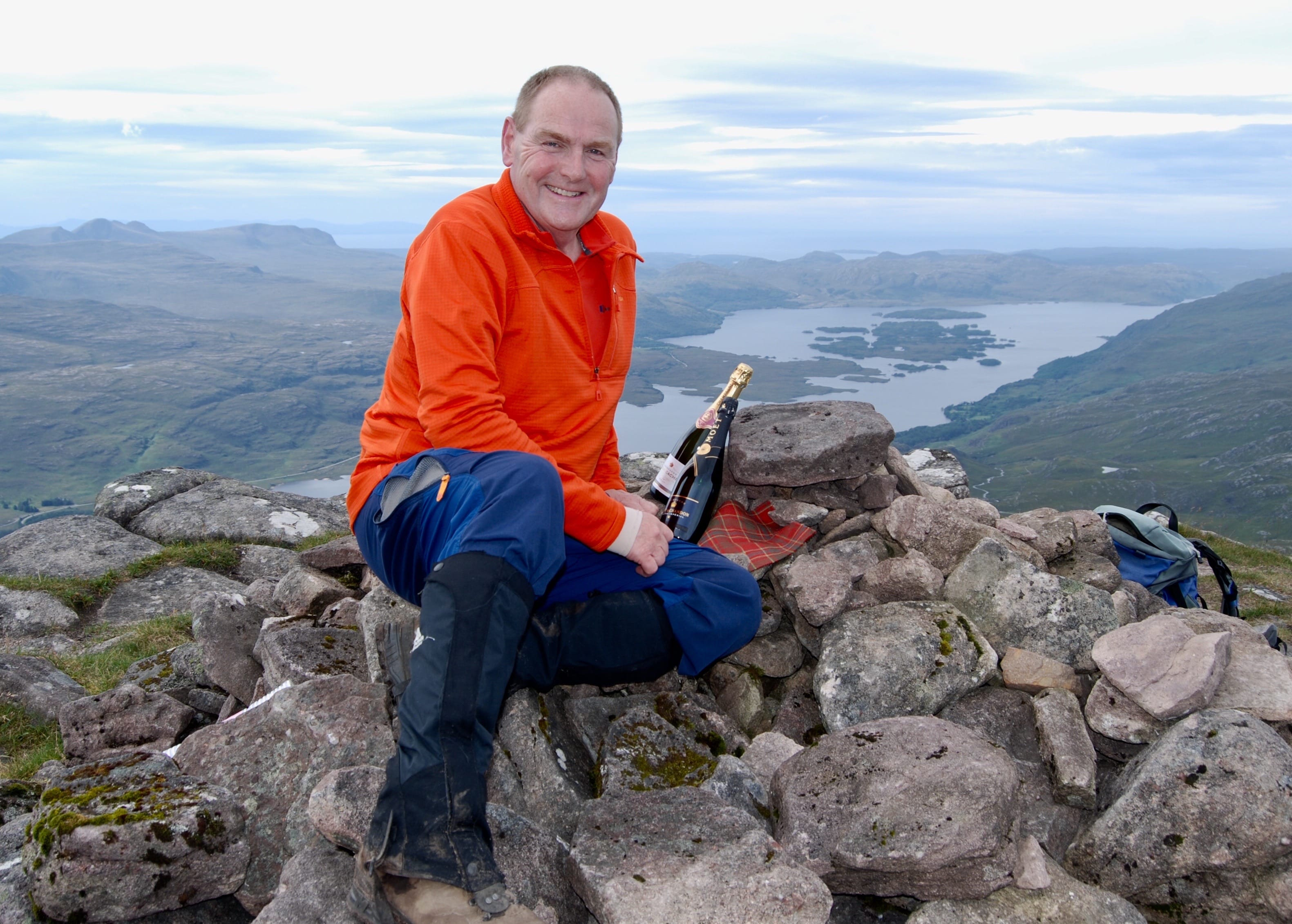 THE FINAL SUMMIT: Hugh William Munro at the top of Slioch, complete with Munro tartan and celebratory drink