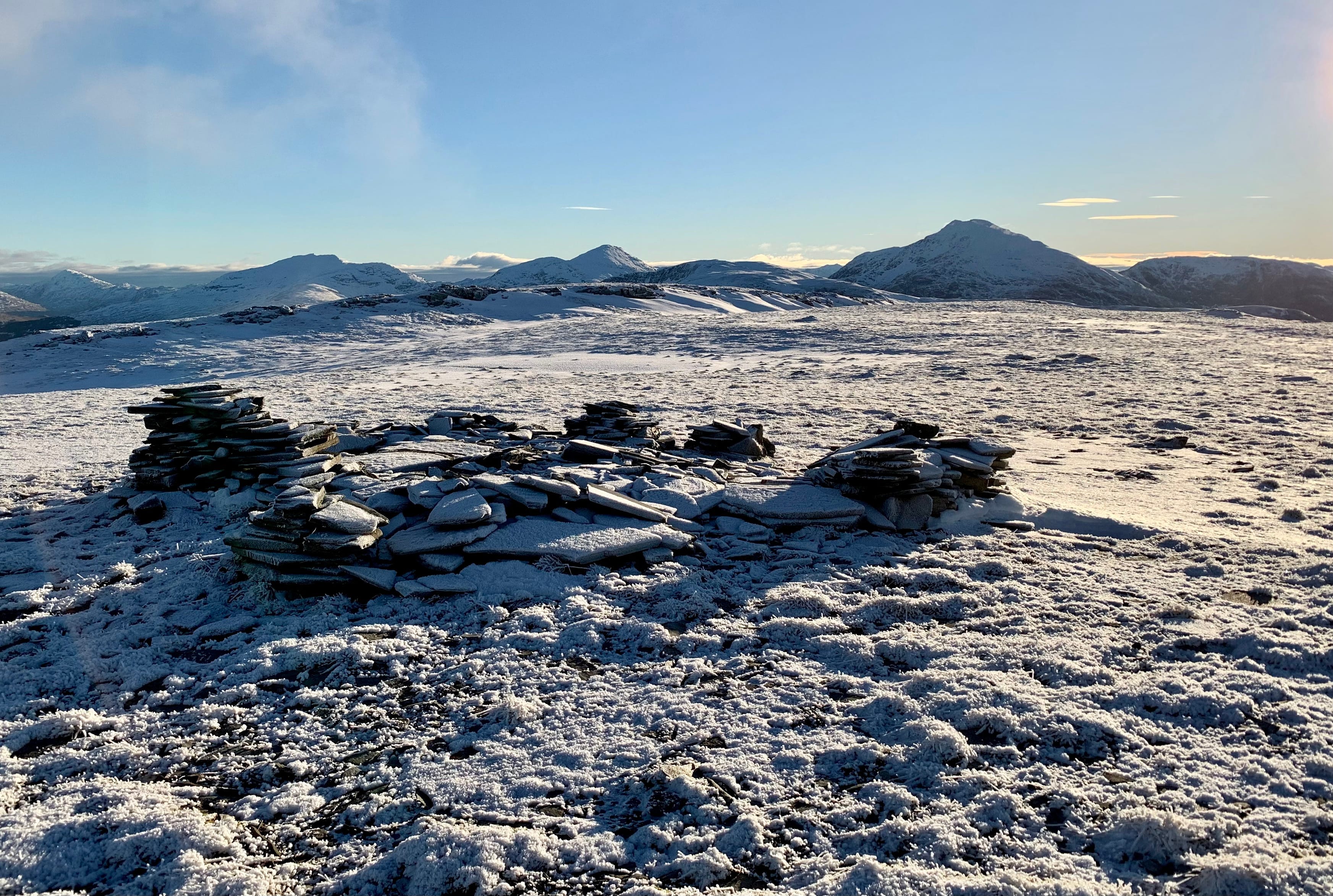 FREEZE FRAME: Brilliant light on distant peaks from the summit cairn on the frozen plateau of Beinn Udlaidh
