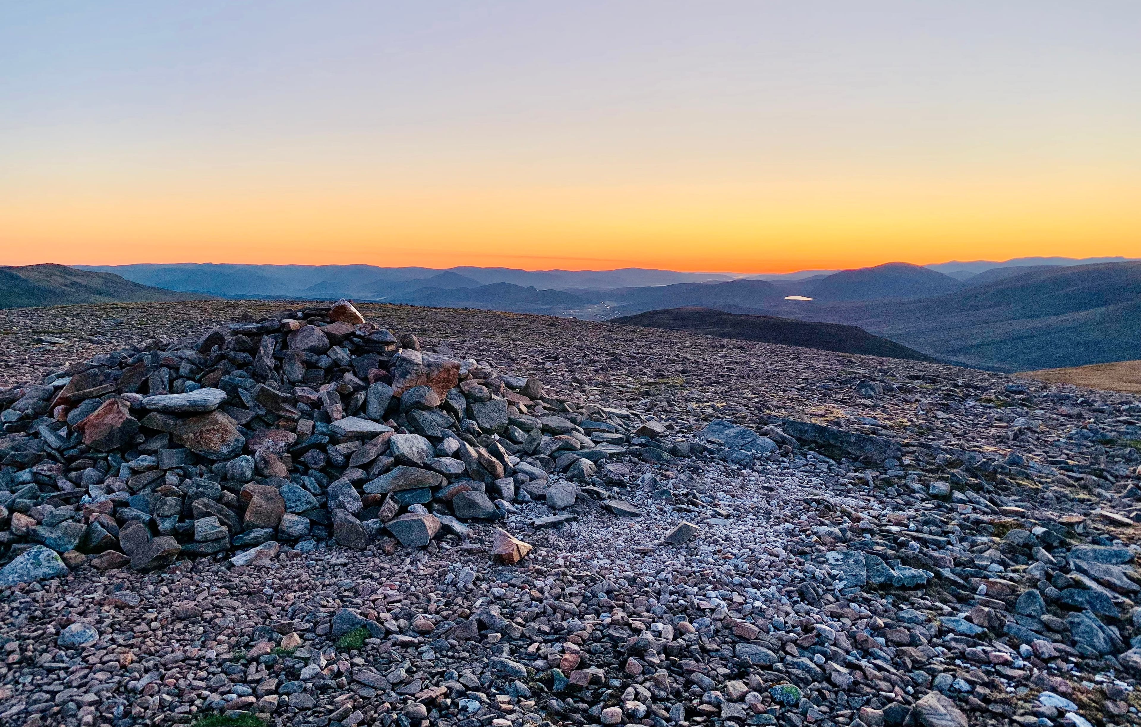 JUST BEFORE SUNRISE: Watching the sky light up and waiting for the fireworks on the summit of Geal-charn